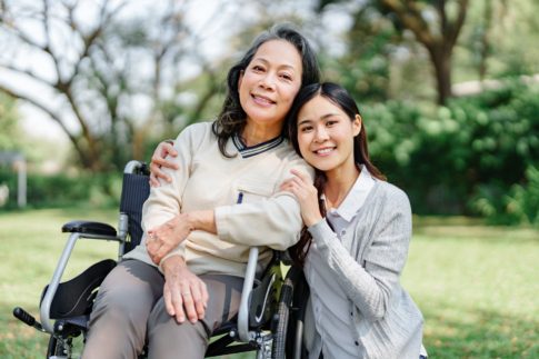 Caregiver smiles with her senior family member