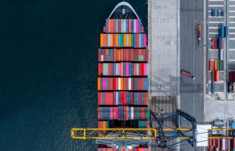 Ship in port loading shipping containers representing trade and tariffs